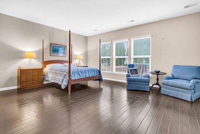 bedroom with dark hardwood / wood-style flooring