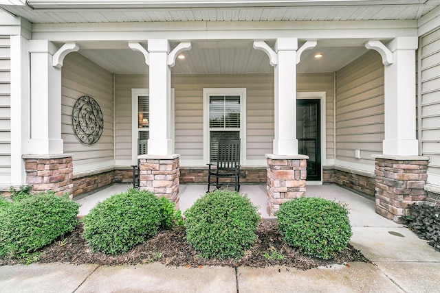 view of exterior entry with a porch