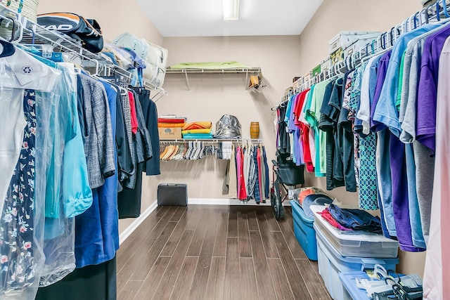 spacious closet with dark hardwood / wood-style floors