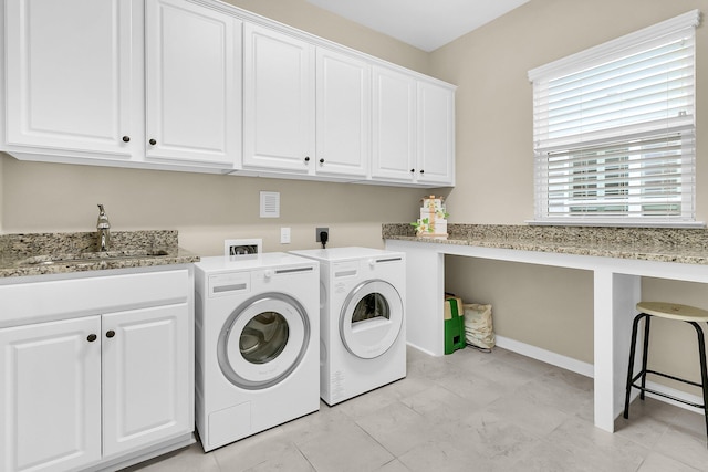 laundry room with cabinets, washer and clothes dryer, and sink