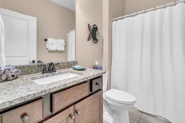 bathroom with tile patterned flooring, vanity, and toilet