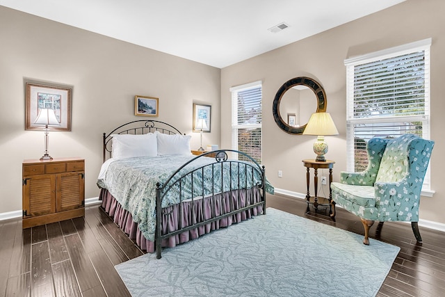 bedroom with dark hardwood / wood-style flooring