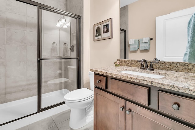 bathroom with vanity, toilet, tile patterned floors, and a shower with door