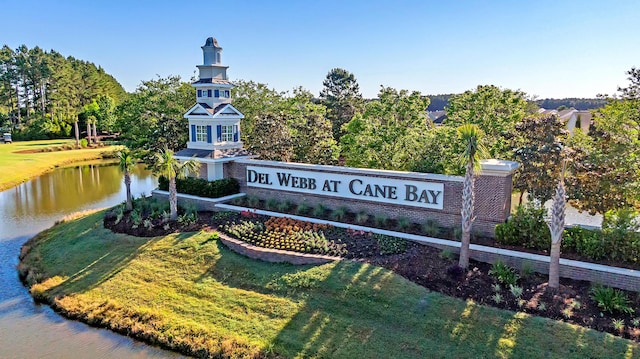 view of community with a lawn and a water view