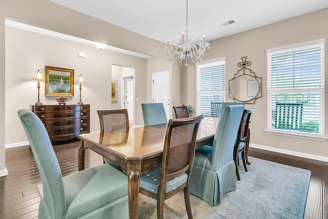 dining room featuring an inviting chandelier and dark hardwood / wood-style flooring