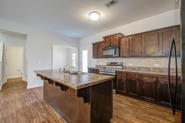 491 Fox Sparrow Ct, Summerville, SC 29486 - kitchen with a sink, black microwave, dark wood-style floors, visible vents, and stainless steel electric stove