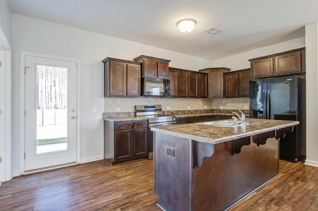 491 Fox Sparrow Ct, Summerville, SC 29486 - kitchen with dark wood finished floors, a sink, visible vents, dark brown cabinets, and black appliances