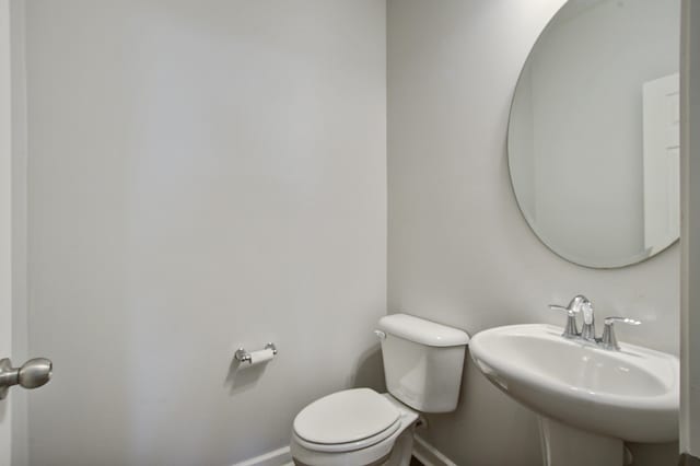 491 Fox Sparrow Ct, Summerville, SC 29486 - bathroom featuring baseboards, toilet, and a sink