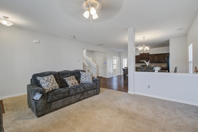 491 Fox Sparrow Ct, Summerville, SC 29486 - living room with carpet flooring, visible vents, baseboards, stairs, and ceiling fan with notable chandelier