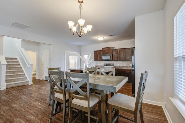 491 Fox Sparrow Ct, Summerville, SC 29486 - dining area featuring stairs, dark wood finished floors, baseboards, visible vents, and an inviting chandelier