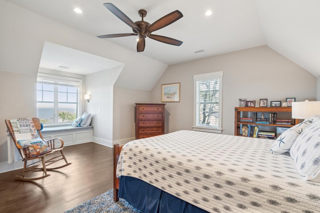 bedroom featuring baseboards, dark wood-type flooring, a ceiling fan, and vaulted ceiling