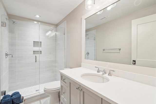 bathroom featuring visible vents, toilet, a stall shower, recessed lighting, and vanity