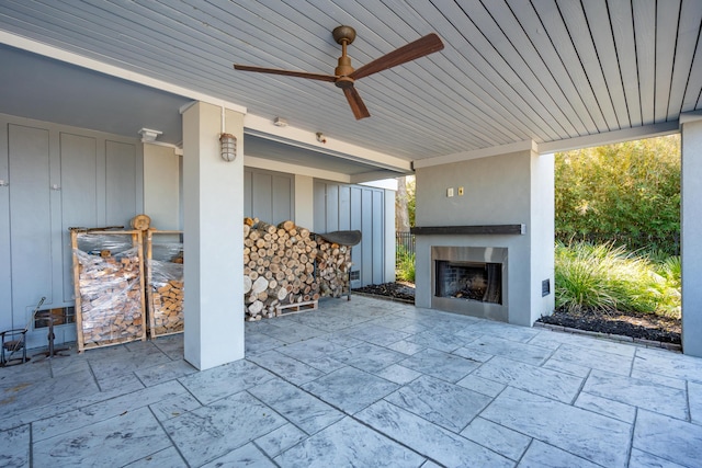 view of patio featuring exterior fireplace and ceiling fan