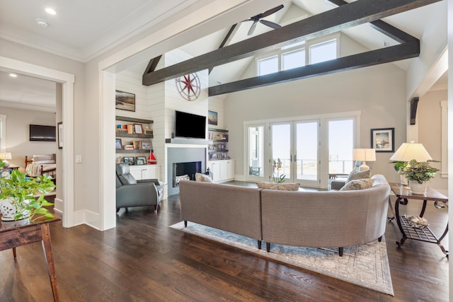 living room with beamed ceiling, wood finished floors, a fireplace, and ornamental molding