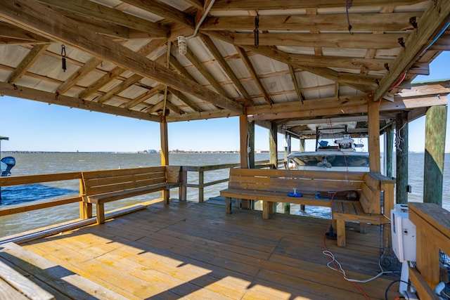 dock area featuring boat lift and a water view