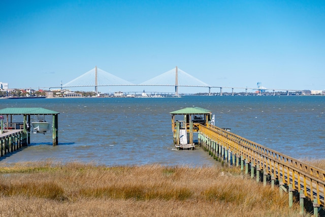 view of dock with boat lift and a water view