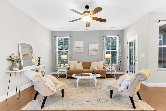 living room featuring hardwood / wood-style floors and ceiling fan