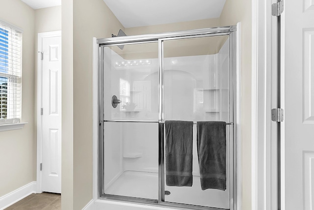 bathroom with tile patterned floors and a shower with shower door