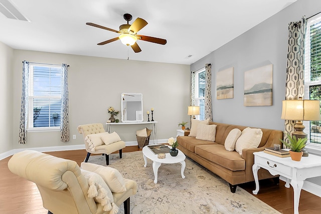 living room with light hardwood / wood-style floors, a wealth of natural light, and ceiling fan