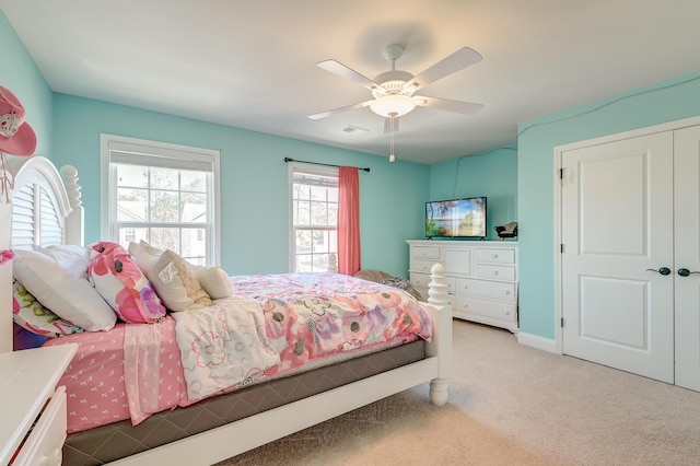 carpeted bedroom featuring ceiling fan and a closet