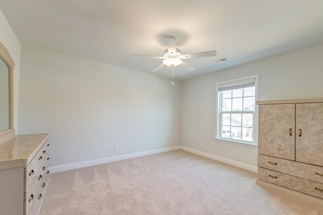 unfurnished bedroom with ceiling fan and light colored carpet