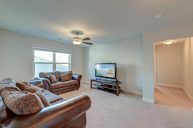 carpeted living room with ceiling fan