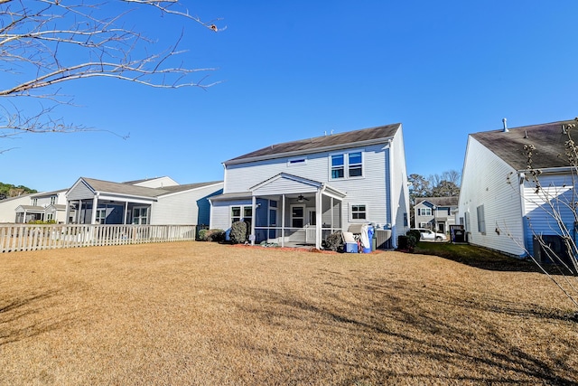 back of house featuring a yard and ceiling fan