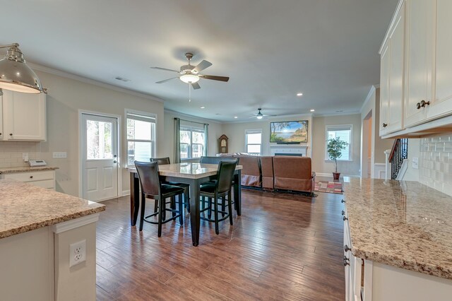 dining room featuring ceiling fan, dark hardwood / wood-style flooring, and ornamental molding