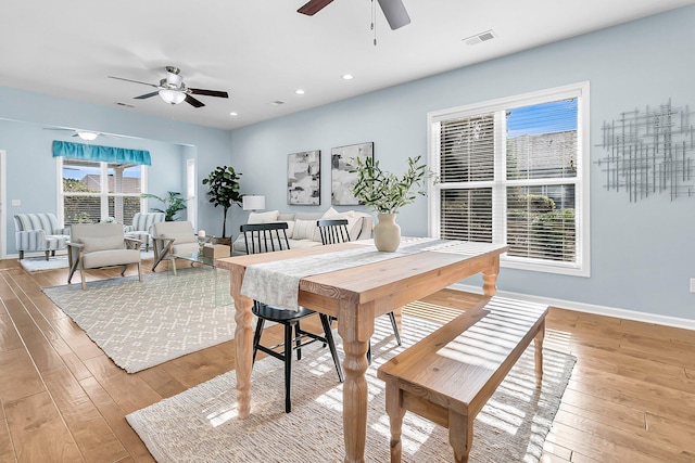 dining area with ceiling fan and light wood-type flooring