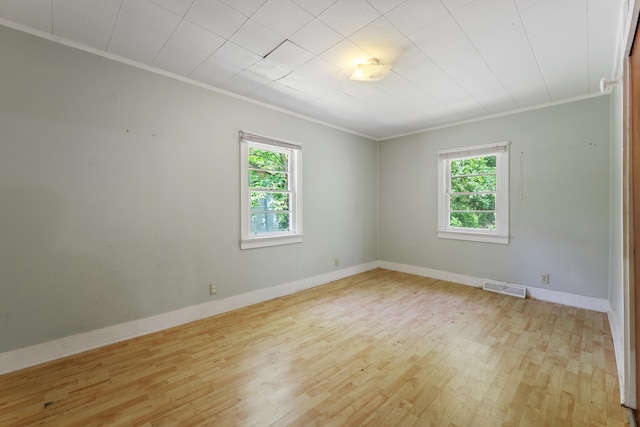 unfurnished room with crown molding and a wealth of natural light