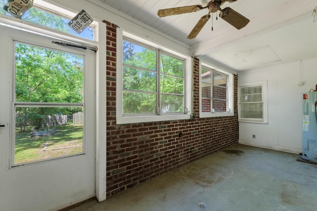 unfurnished sunroom featuring water heater, ceiling fan, and plenty of natural light