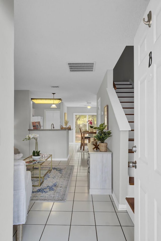 corridor featuring light tile patterned flooring