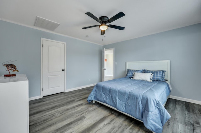 bedroom with hardwood / wood-style flooring, ceiling fan, and ornamental molding