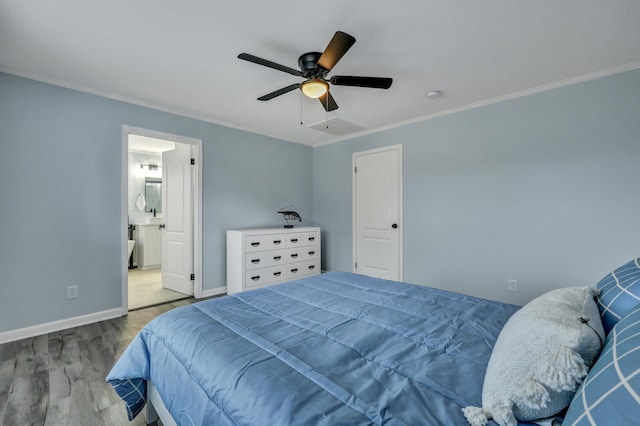 bedroom featuring ornamental molding, ensuite bathroom, ceiling fan, and light hardwood / wood-style flooring