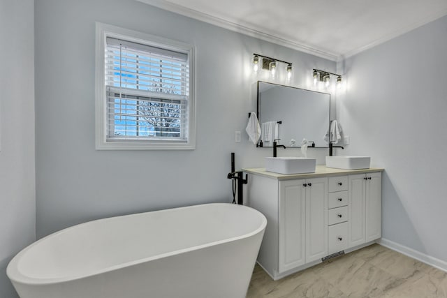 bathroom featuring vanity, ornamental molding, and a tub