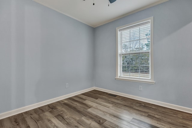 spare room featuring wood-type flooring, ornamental molding, and ceiling fan