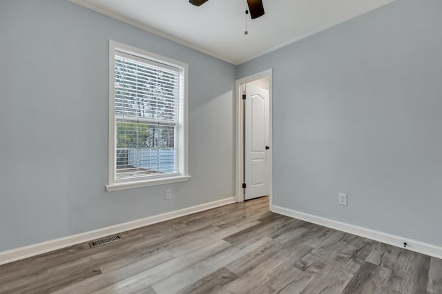 empty room featuring crown molding, ceiling fan, and light hardwood / wood-style flooring