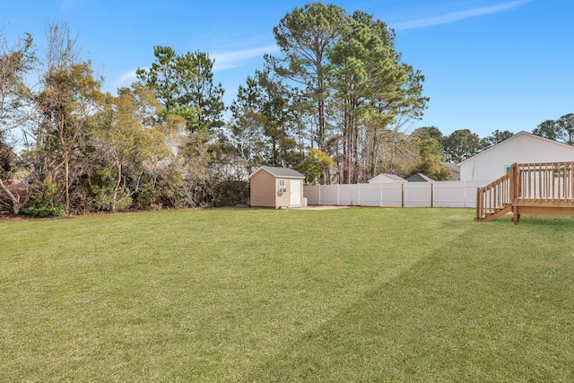 view of yard featuring a wooden deck and a shed