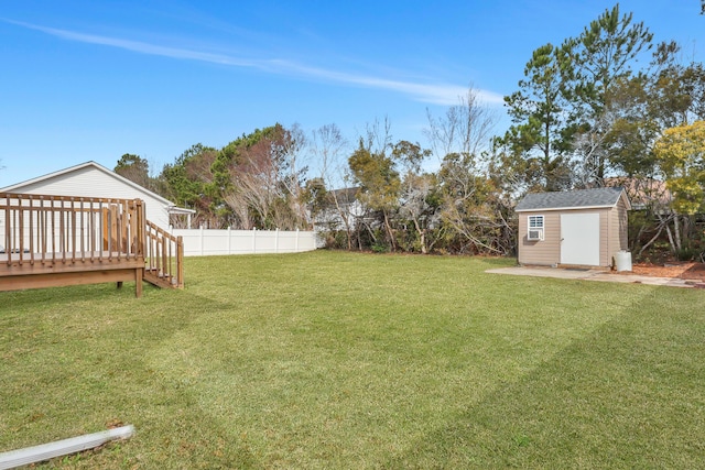 view of yard with a deck and a storage shed