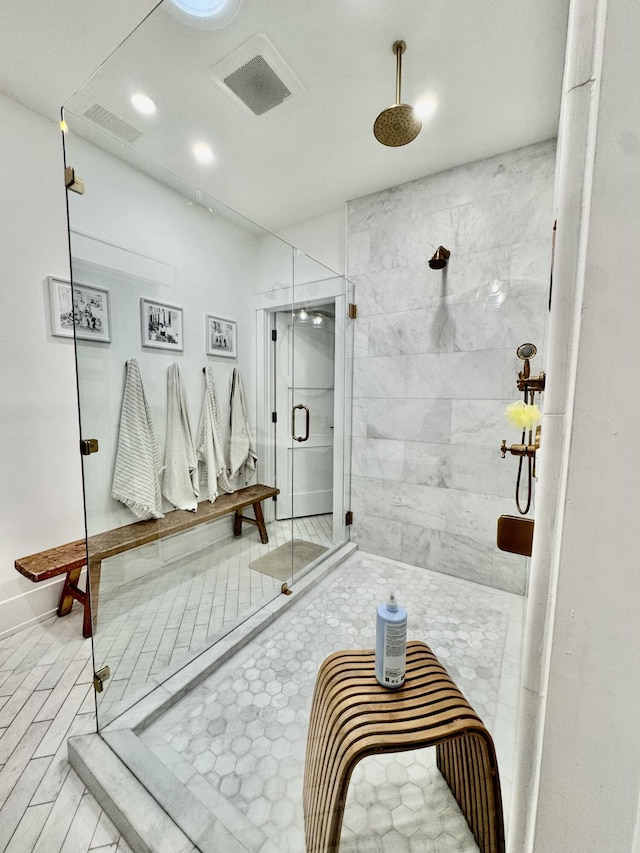 bathroom with a shower with door