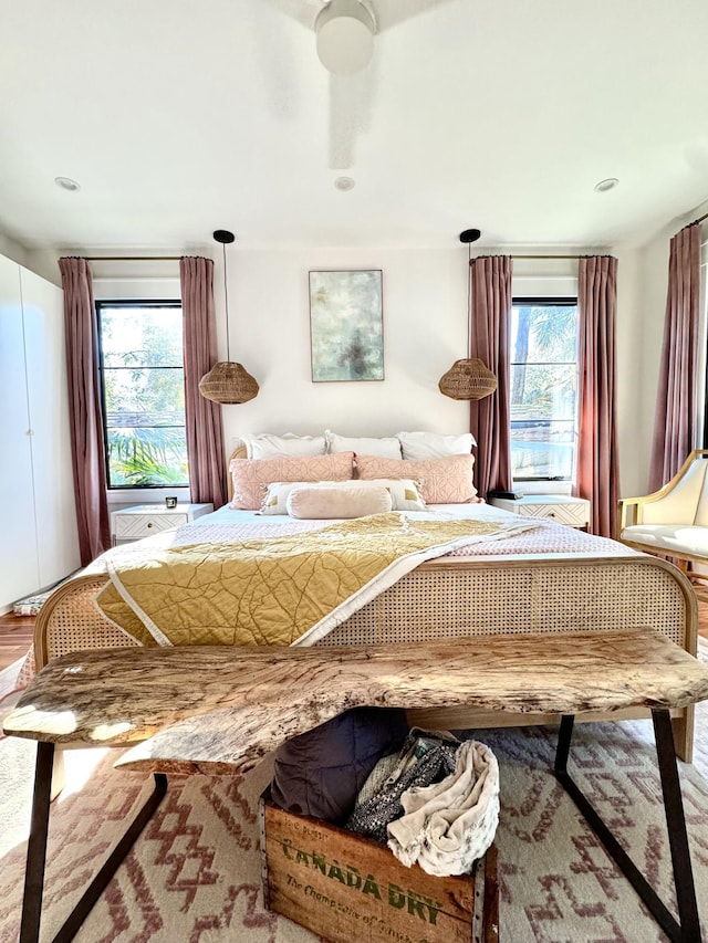 bedroom featuring ceiling fan and multiple windows