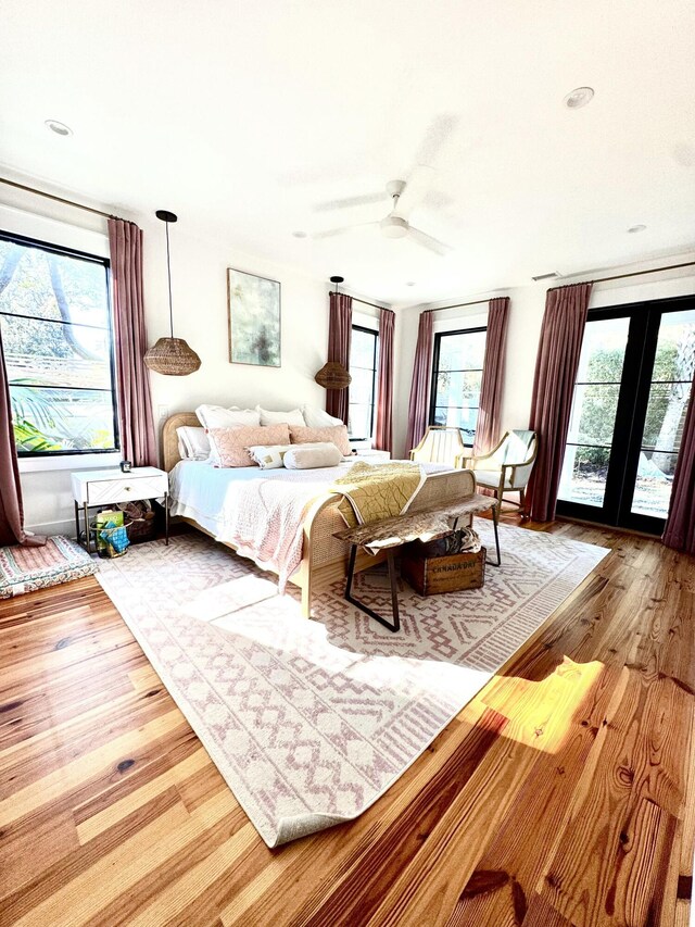 bedroom featuring ceiling fan, access to outside, and light wood-type flooring