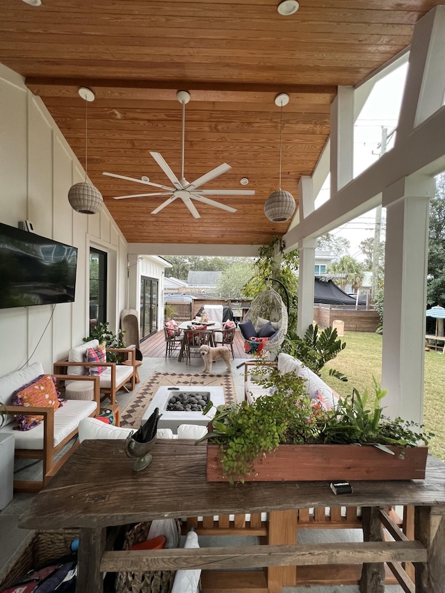 view of patio / terrace with ceiling fan and an outdoor living space