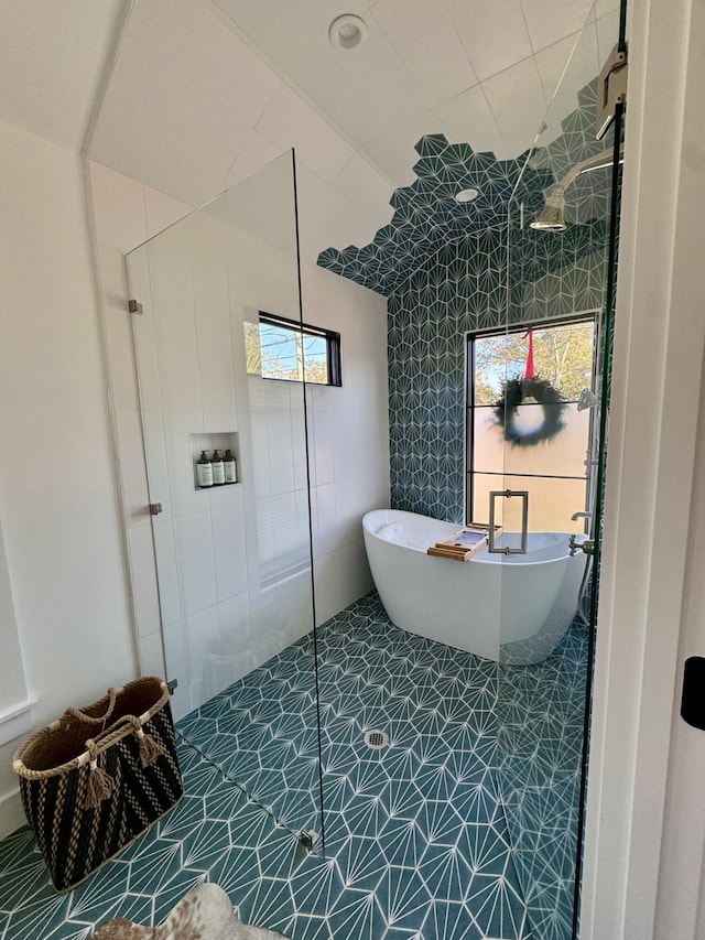 bathroom with tile patterned floors and separate shower and tub