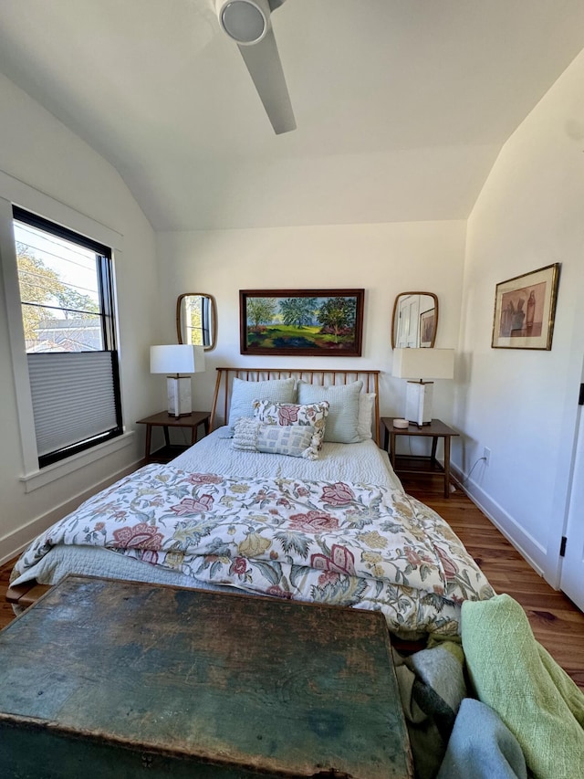 bedroom with ceiling fan, lofted ceiling, and dark hardwood / wood-style floors