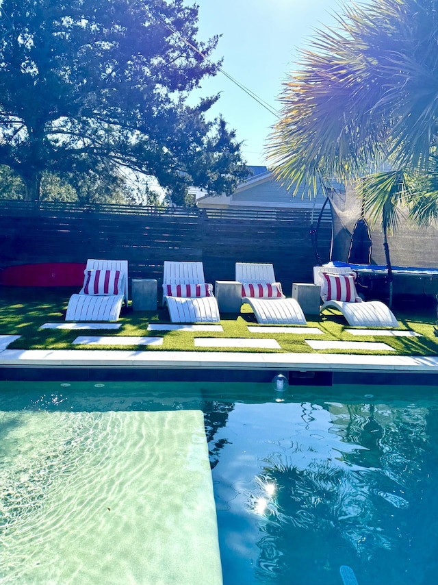 view of swimming pool featuring a trampoline