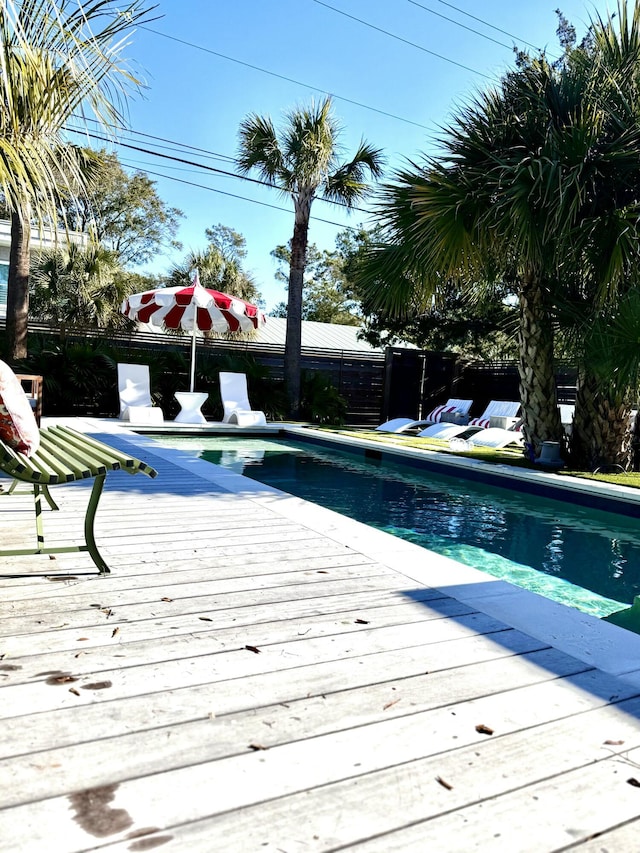 view of swimming pool featuring a wooden deck