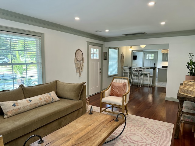 living room with dark hardwood / wood-style floors and ornamental molding