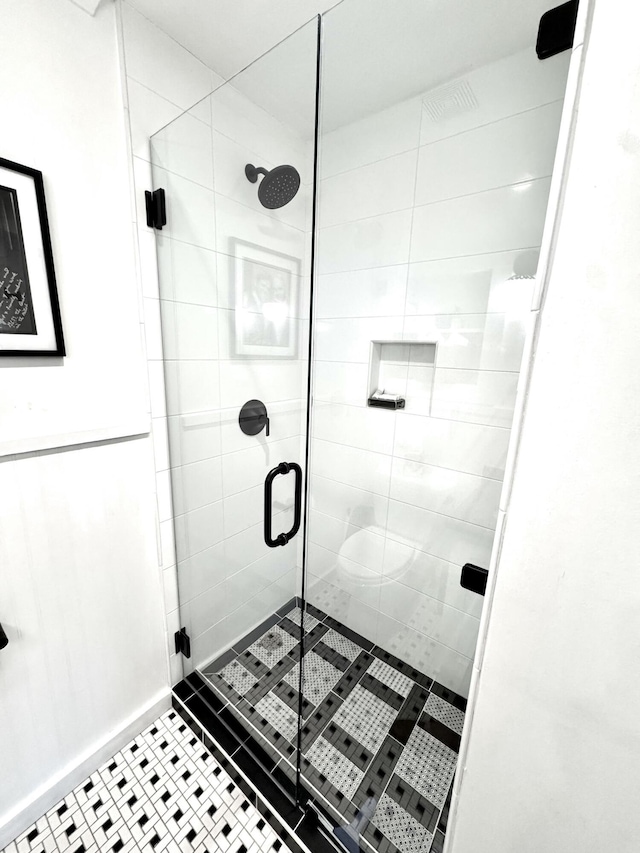 bathroom featuring walk in shower and tile patterned floors