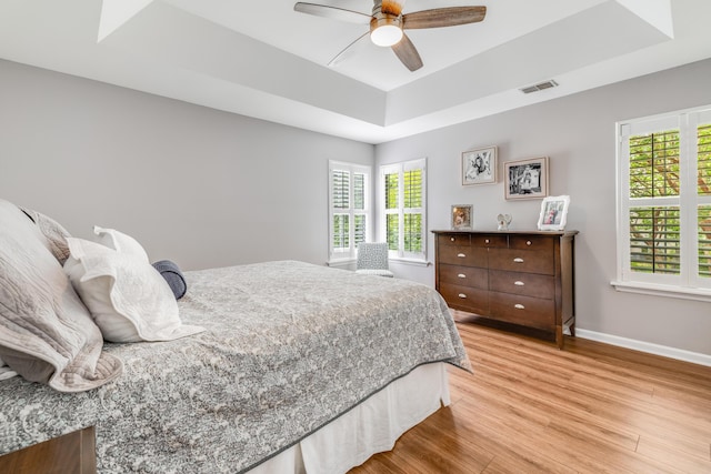 261 Mossy Oak Way, Mount Pleasant, SC 29464 - bedroom with a raised ceiling, light wood-style floors, baseboards, and a ceiling fan